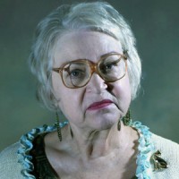 Zina Jacinto Scowling older woman with short gray hair